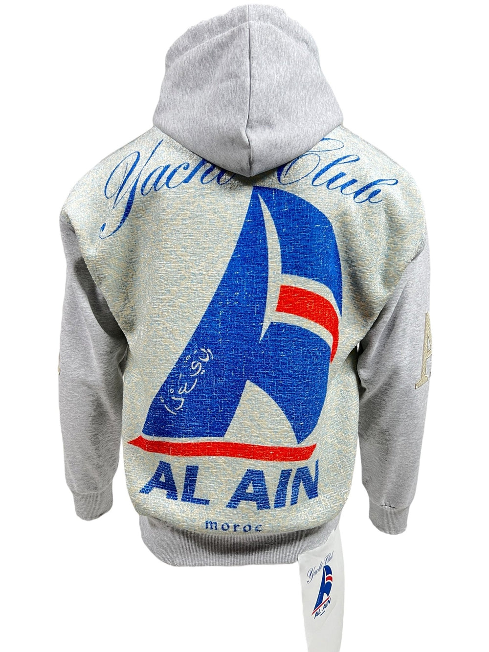 Grey AL AIN AHOX S150 YACHT LIMITED hoodie with large blue, red, and white yacht club-themed graphic on back. "Yacht Club" written at top, "AL AIN" at bottom. Blue and white yacht emblem in center. Perfect streetwear piece made from 100% cotton by AL AIN.