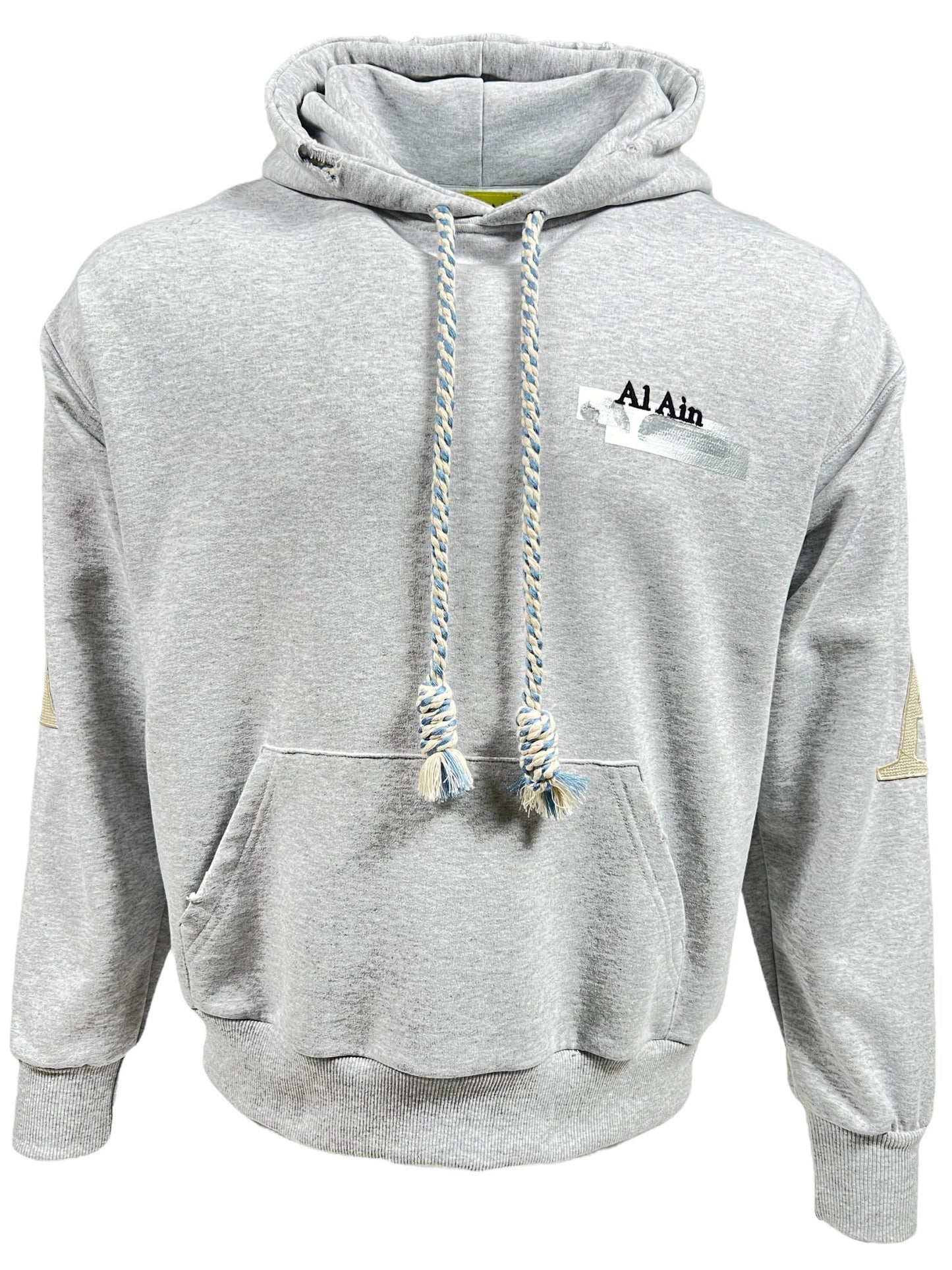 A grey AL AIN AHOX S150 YACHT LIMITED hoodie, made from 100% cotton, features a front pocket and drawstrings. The text "Al Ain" is stylishly displayed on the left side of the chest, making it a must-have piece for streetwear enthusiasts.