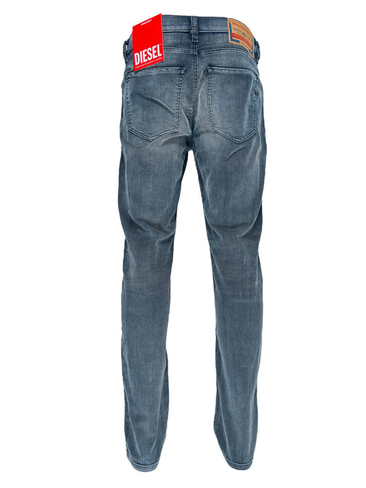 A pair of DIESEL brand slim jeans with a visible logo tag on a white background.