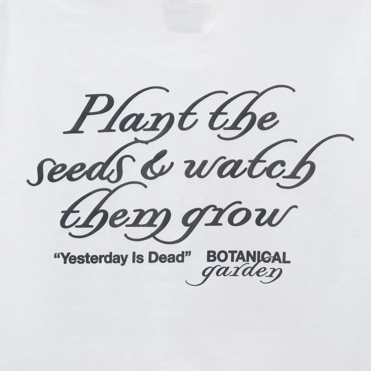 YESTERDAY IS DEAD SUCCULENT TEE WHITE t-shirt featuring the phrase "plant the seeds & watch them grow 'YESTERDAY IS DEAD' botanical garden" printed in stylized black font.
