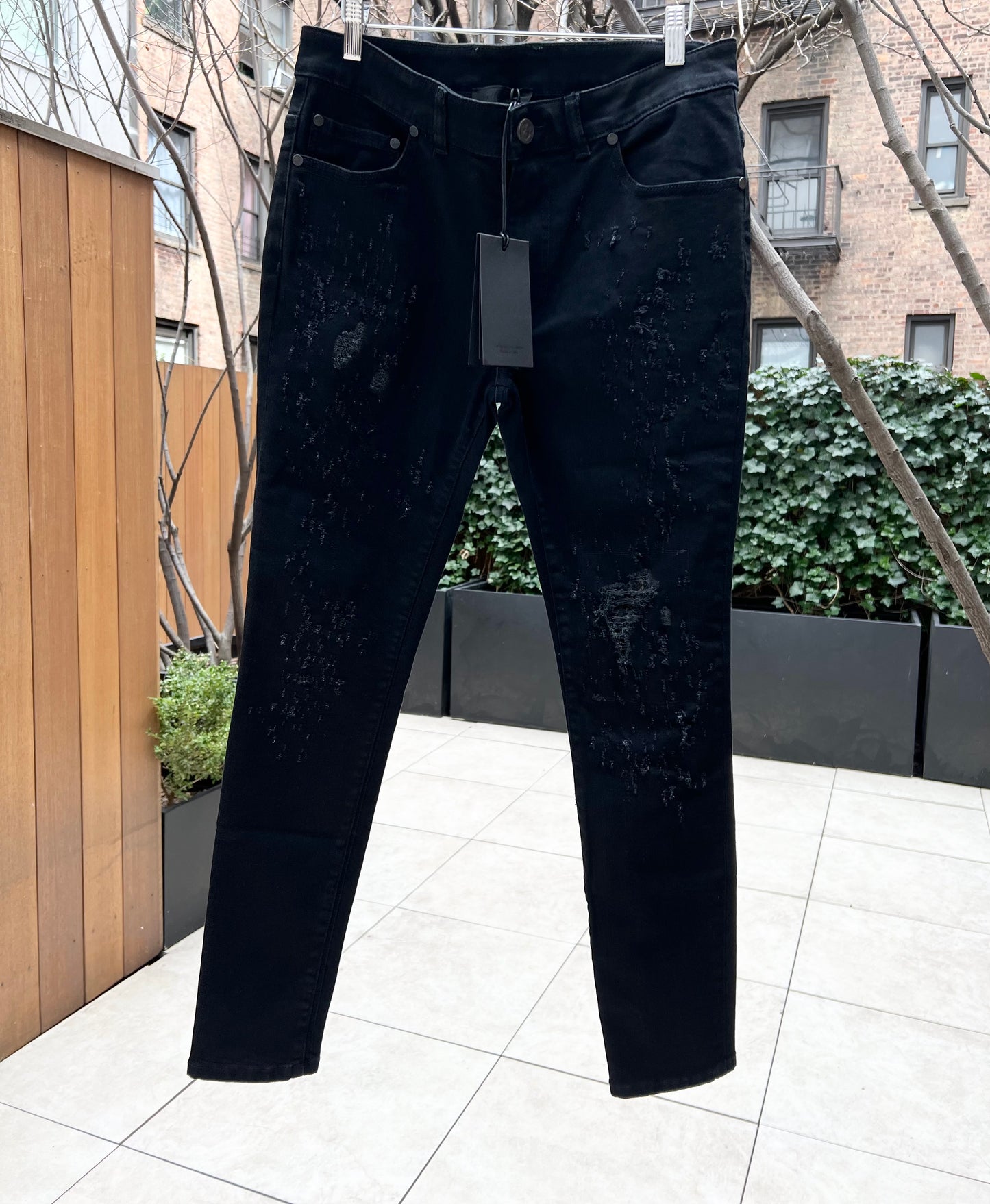 RH45 premium denim jeans with tags displayed outdoors.