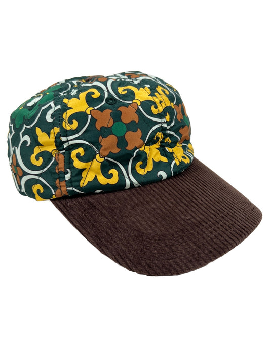 A DROLE DE MONSIEUR hat in Faience Green with a floral pattern.