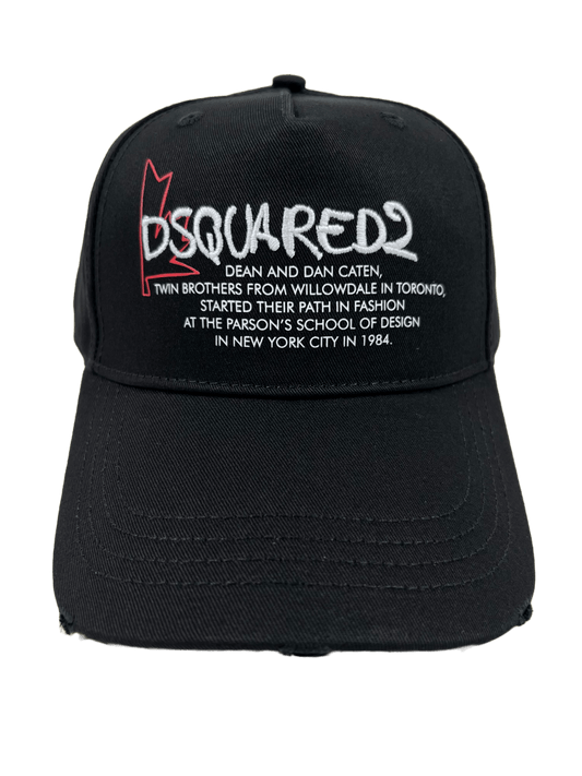 A black, 100% cotton hat with the words DSQUARED2 BCM0656 BASEBALL CAP GABARDINE-NERO embroidered on it.