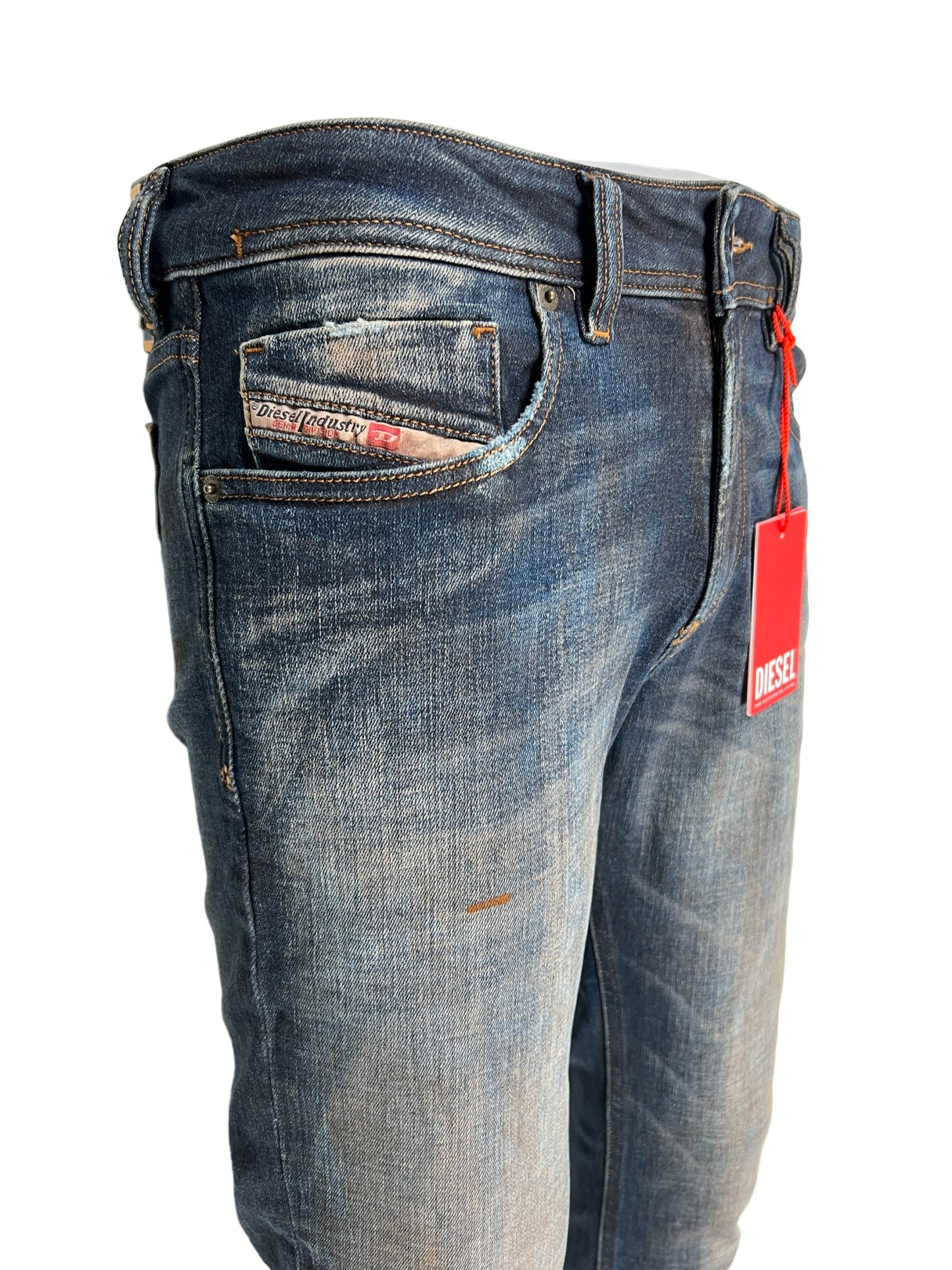 A pair of DIESEL JEANS 1979 SLEENKER 9H76 skinny style jeans with a tag on the back.
