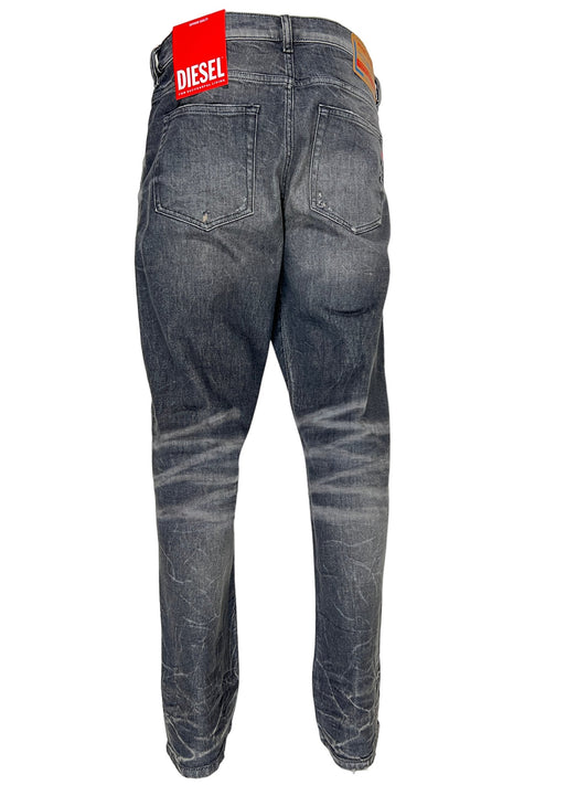 A pair of men's DIESEL JEANS 2020 D-VIKER 9H51 dark blue wash jeans with a label on the back.
