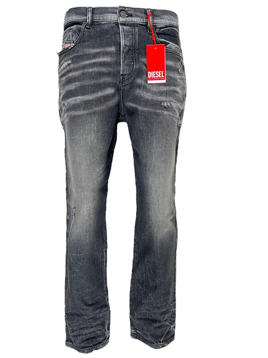 A pair of Diesel men's jeans with a button fly and a tag on them.