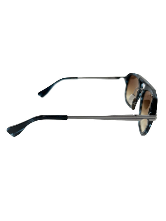 A pair of DITA sunglasses with a black frame and blue-yellow lenses, designed in Japan.