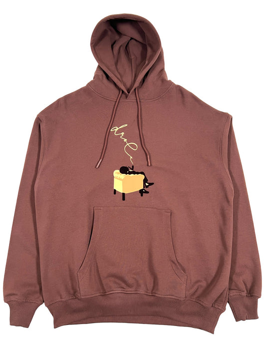 A brown DROLE DE MONSIEUR hoodie with a cat on it.