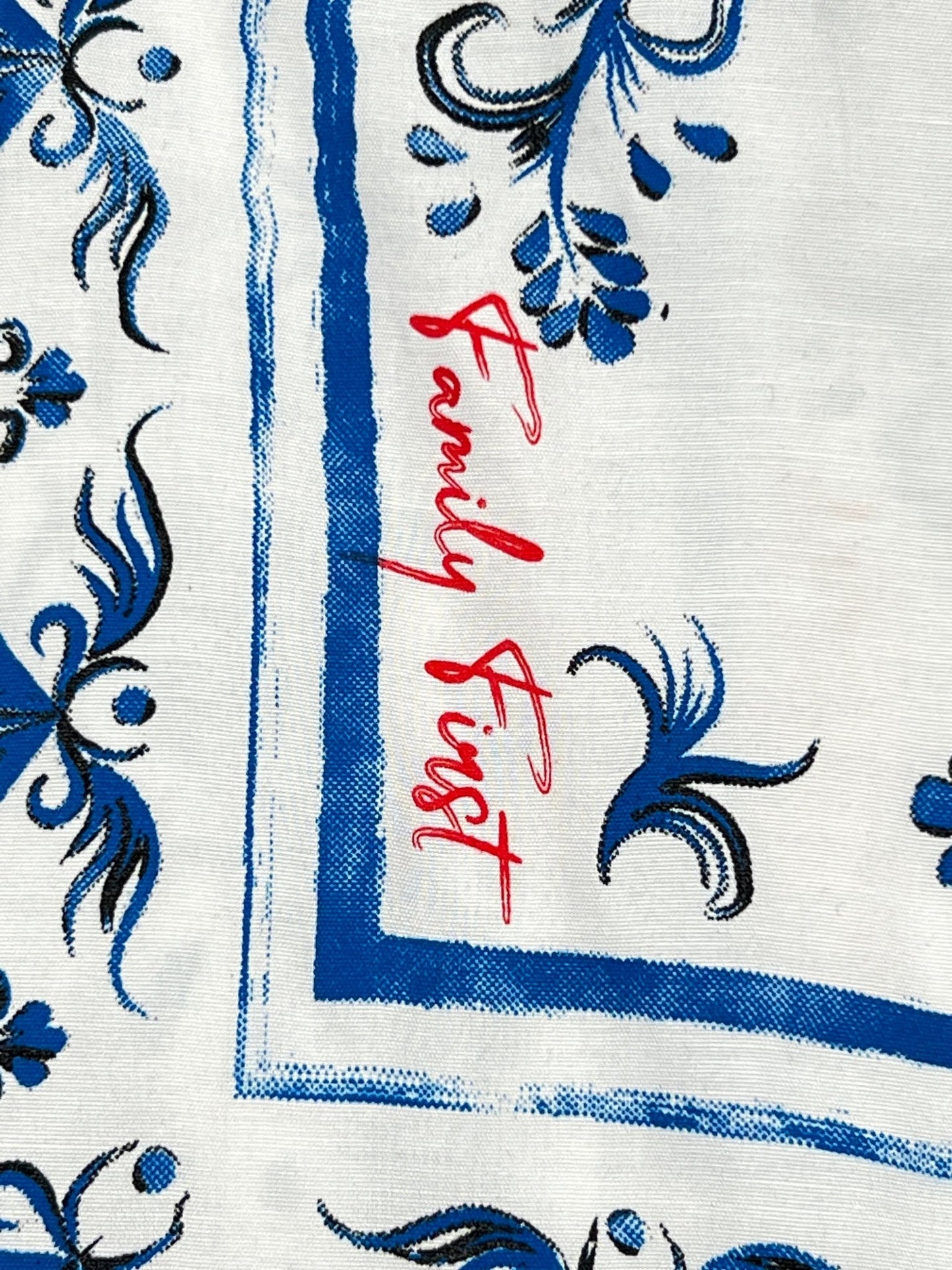 A blue and white FAMILY FIRST shirt with the word family first written on it.