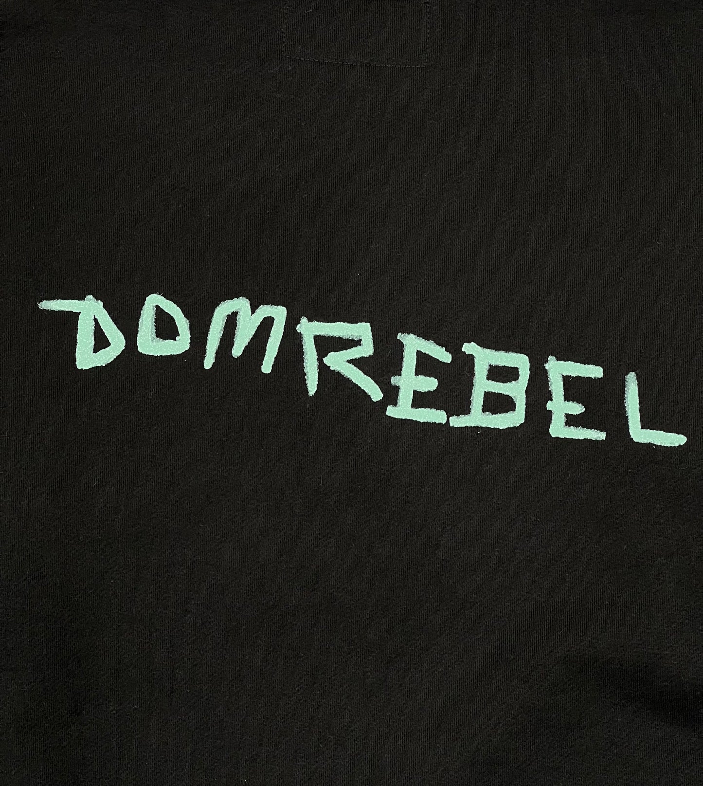 A black cotton t-shirt with the word DOMREBEL SHOPPER SWEATSHIRT BLACK written on it by DOM REBEL.