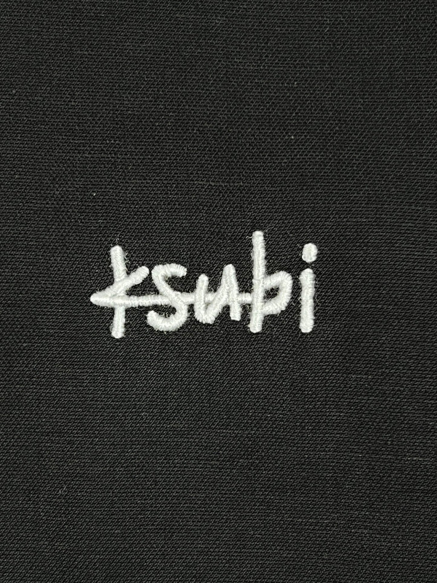 A close up of a black KSUBI DOWNTOWN RESORT SS SHIRT with the word Ksubi written on it.