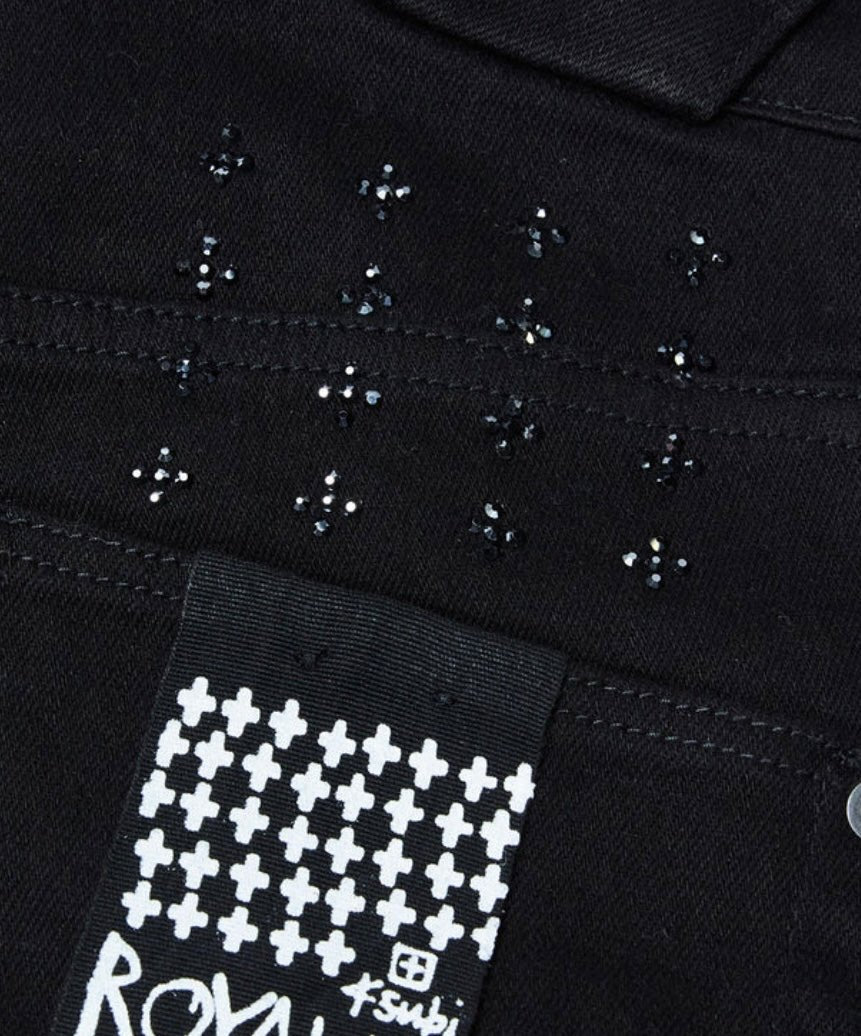 A black KSUBI JEANS CHITCH KRYSTAL BLACK denim jacket with a crystal cross on it.