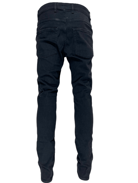The back view of a pair of REPRESENT DESTROYER DENIM BLACK jeans.