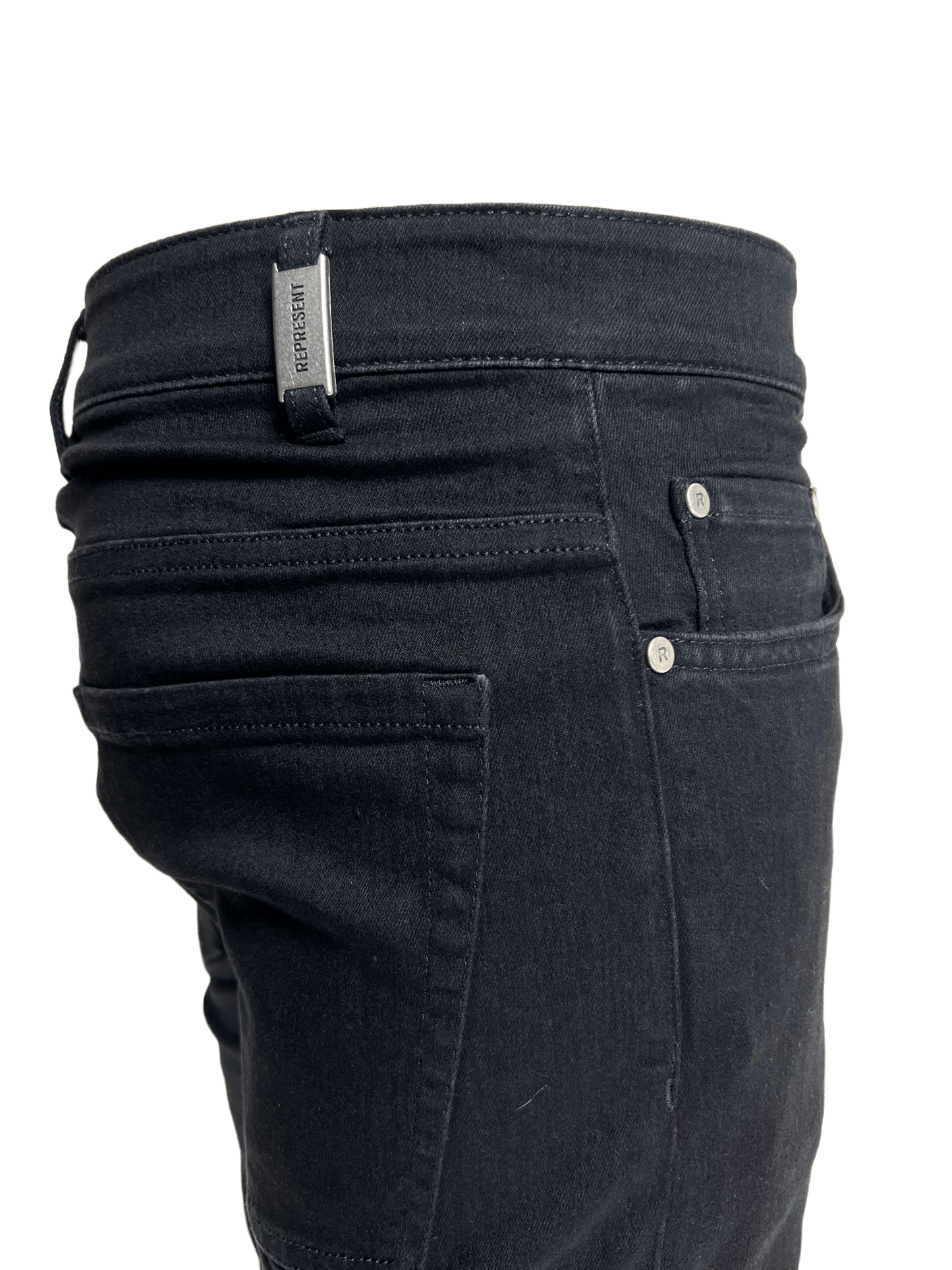 The back pocket of a pair of distressed REPRESENT M07044 DESTROYER DENIM BLACK jeans.