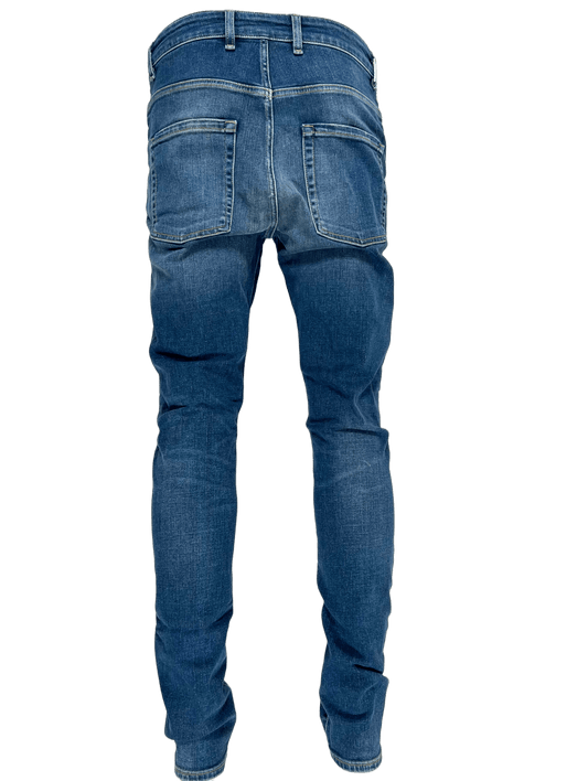 The back view of a pair of REPRESENT M07044 DESTROYER DENIM CLASSIC BLUE FW22 jeans with distressed detailing.