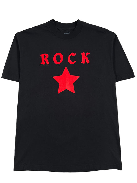 A PLEASURES black cotton t-shirt with a screen-printed red star on it.