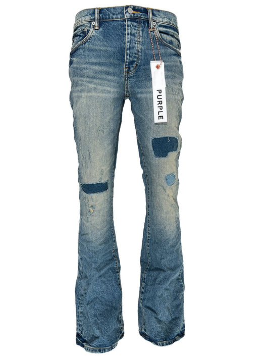 A pair of men's Purple Brand P004-PRFL Patch Repair Flare Mid Indigo jeans with a tag on them.