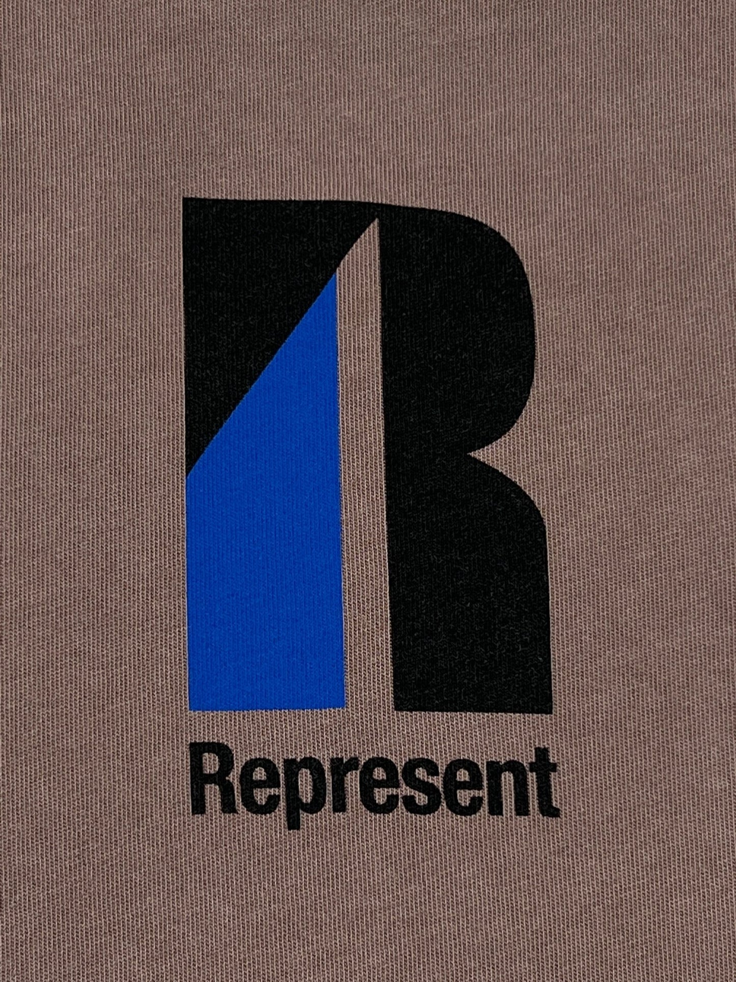 A brown graphic t-shirt with the word "represent" on it.