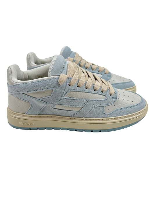A pair of REPRESENT sneakers in light blue and beige, crafted from tumbled leather.