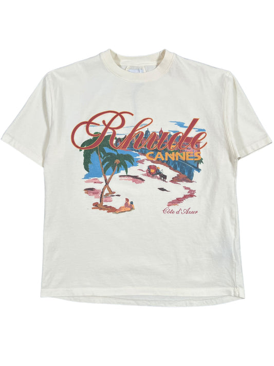 A RHUDE AND CANNES BEACH TEE WHT depicting an image of a beach and palm trees, Made In USA.