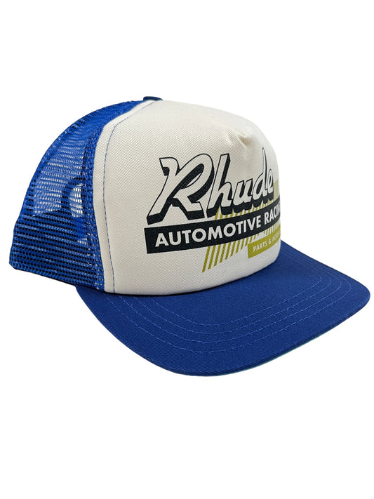 A blue and white RHUDE AUTO RACING TRUCKER HAT NAVY/IVORY with the word rhucks on it.