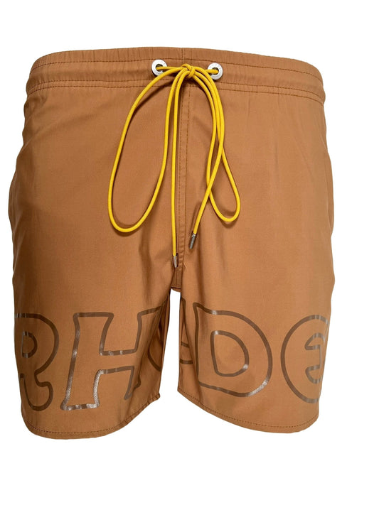 A tan RHUDE CAMEL LOGO swim trunk with the word 'shade' written on it, designed for sun protection.