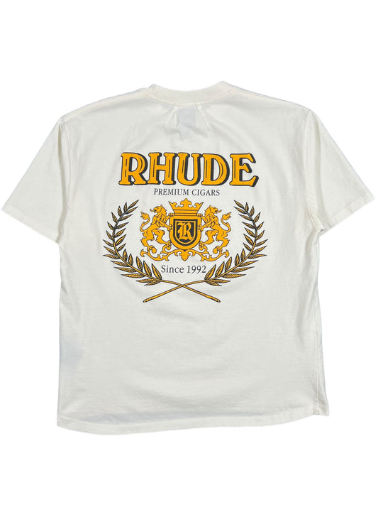 A white graphic t-shirt with the word RHUDE CRESTA CIGAR TEE WHT on it, Made In USA.