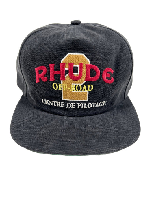 A black hat with the RHUDE OFF ROAD WASHED CANVAS HAT BLK embroidered on it.