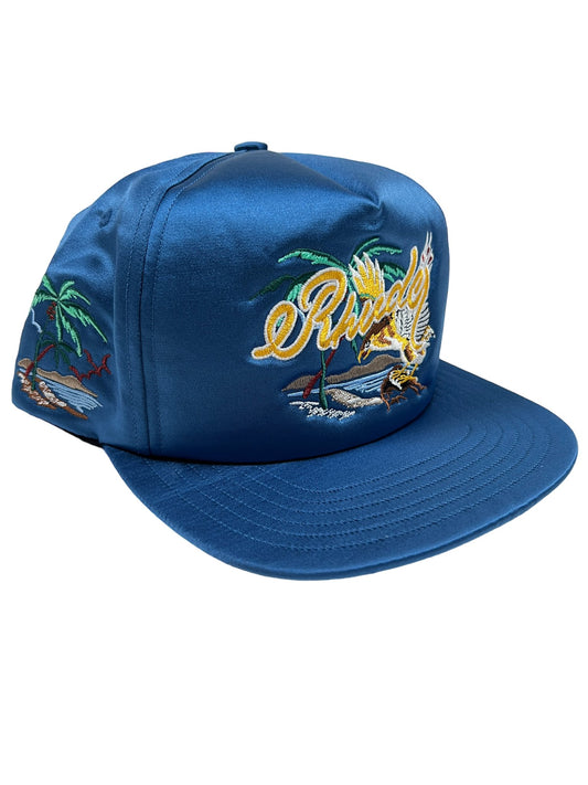 A blue RHUDE polyester hat with an embroidery of a palm tree on it, made in USA.