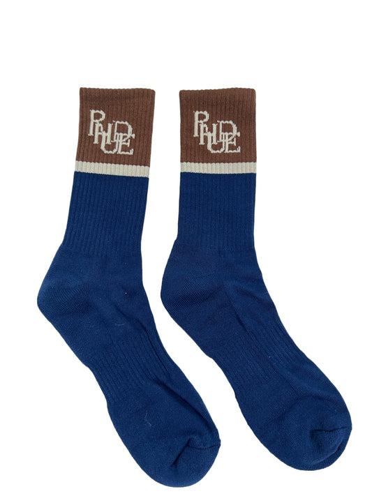 A pair of blue and brown cotton-blend RHUDE SUITING LOGO SOCK NAVY/TAN/BROWN with the word RHUDE on them.