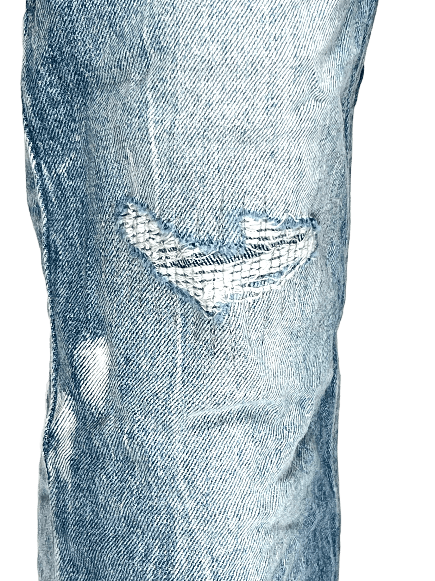 A pair of KSUBI VAN WINKLE HIGHFLY DENIM jeans with holes in them.