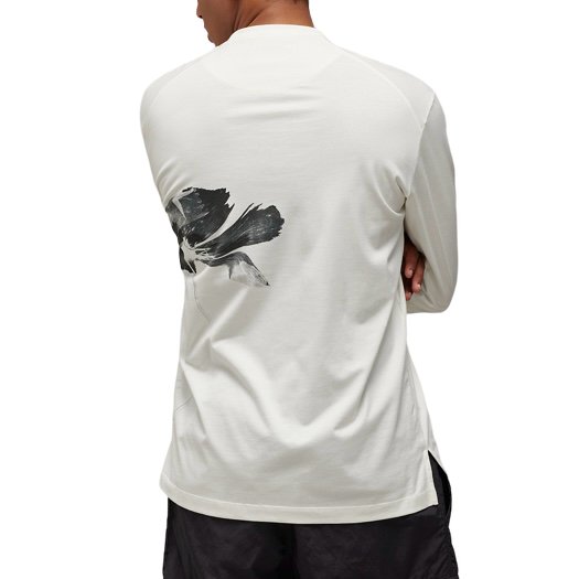 The back of a man wearing a white Y-3 LONG SLEEVE T-SHIRT IV7742 GFX LS TEE OWHITE shirt by ADIDAS x Y-3.