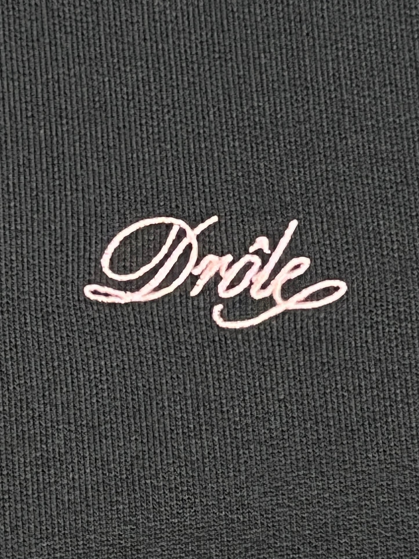 A black cotton sweater with the DROLE DE MONSIEUR SWEATSHIRT C-SW127-CO001-DGN A BANDES GREEN on it.