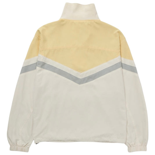 Back view of the HONOR THE GIFT Honor The Gift A-Spring Brushed Poly Track Anorak Bone, a fashion-forward pullover jacket with a vintage style, featuring a high collar, beige and white color blocks, and a gray chevron stripe across the back.