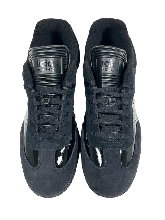 A pair of black ADIDAS x DINGYUN ZHANG IE3176 DYZ SAMBA CBLACK GUM5 shoes with blue accents, viewed from above, showing laces and the brand's logo on the tongue.