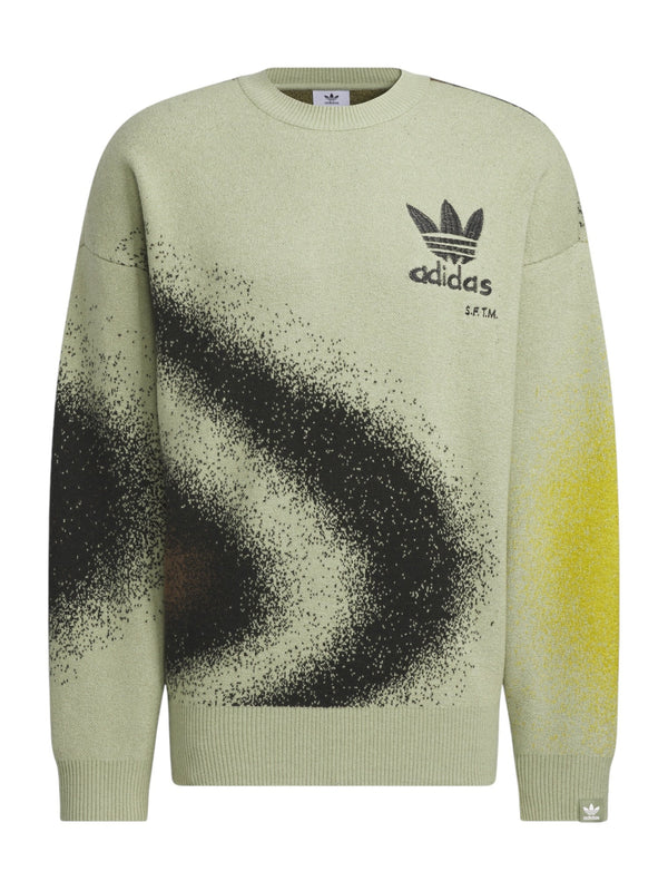 The Adidas X Song For The Mute Ji9643 Adi004 Knitswea Tengr is a sweater from the ADIDAS x SONG FOR THE MUTE collaboration, featuring a green design with a black and yellow abstract pattern and the iconic Trefoil logo on the chest.