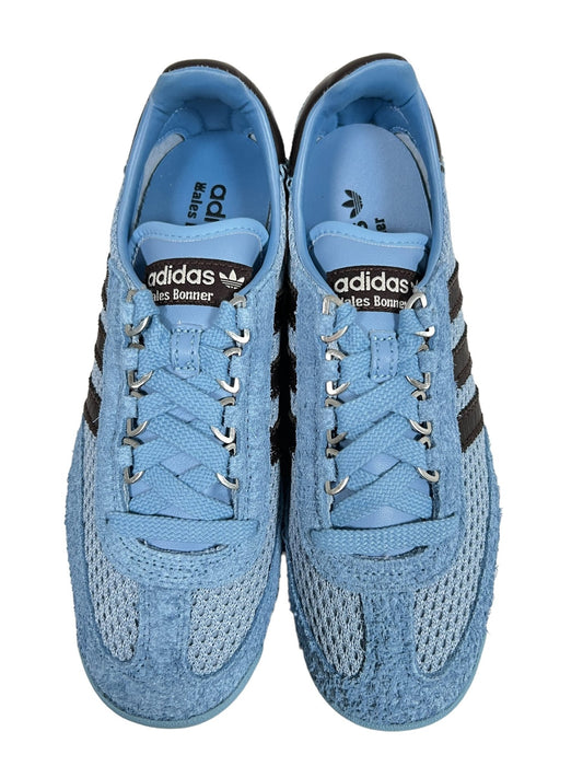 A pair of ADIDAS x WALES BONNER IH3262 WB SL76 ASHBLU/CBLACK Samba sneakers, light blue with dark stripes, displayed from a top view.