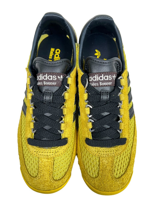 A pair of yellow and black ADIDAS X WALES BONNER IH9906W SL76 sneakers with "WALES BONNER" branding on the tongue.