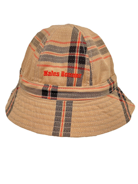 A plaid bucket hat with the "ADIDAS X WALES BONNER IW1163 WB HAT BEIGWB-" embroidered on the front, featuring a pattern of beige, black, and red stripes.