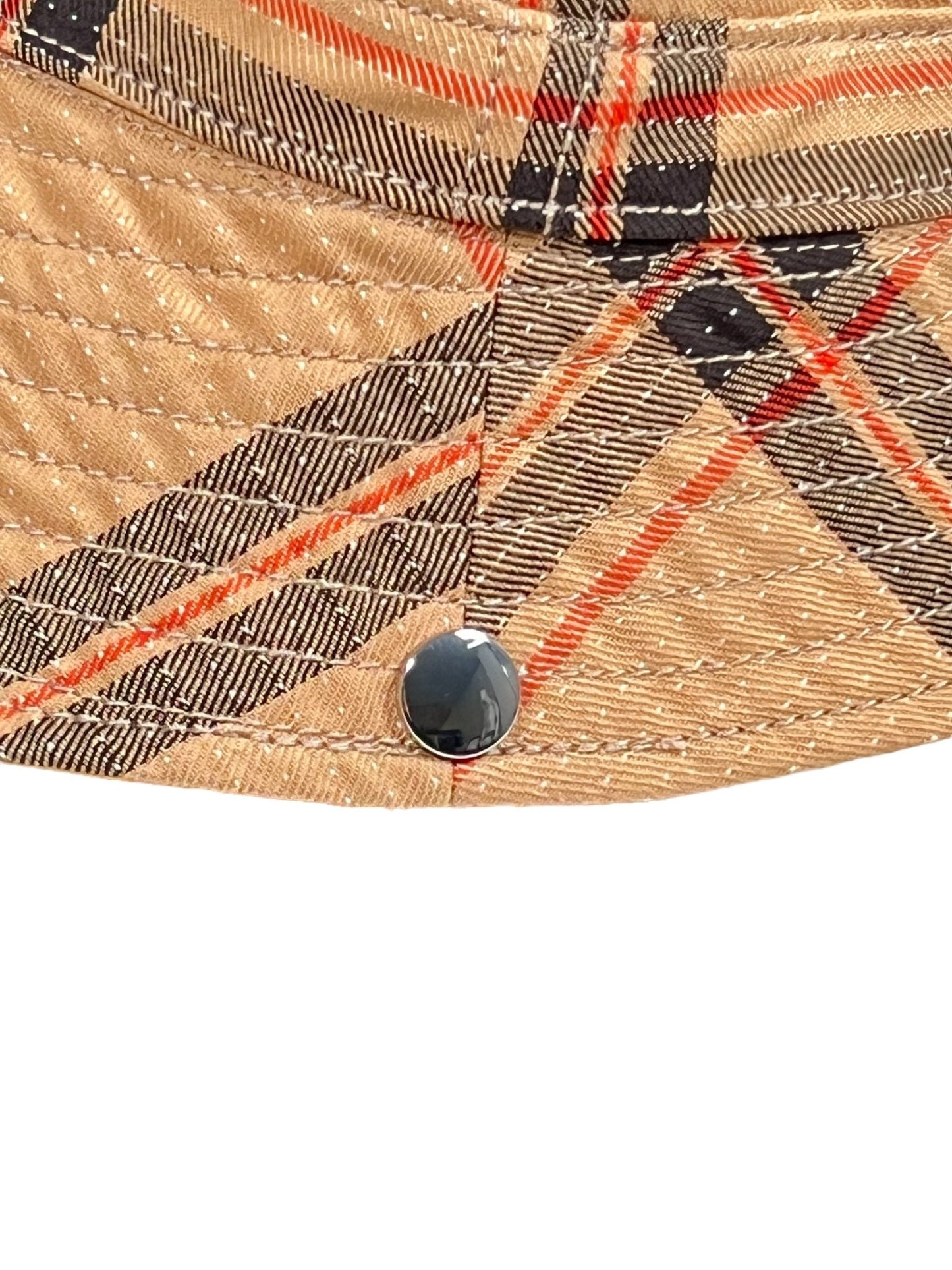 Close-up of a textured ADIDAS X WALES BONNER IW1163 WB HAT BEIGWB- bucket hat with a plaid pattern in orange and black, featuring visible stitching detail and a small black button.