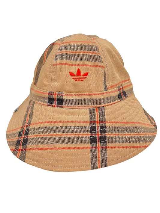 A beige bucket hat with a tartan pattern and a red ADIDAS X WALES BONNER IW1163 WB HAT BEIGWB- logo on the front.