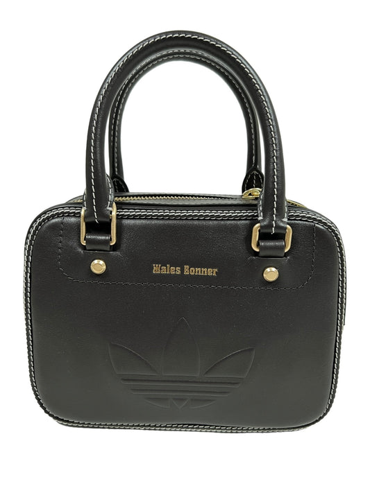 A small black leather handbag with gold accents featuring the ADIDAS X WALES BONNER IX7732 WB BAG S NBROWN logo and the text "Adidas x Wales Bonner" on the front.