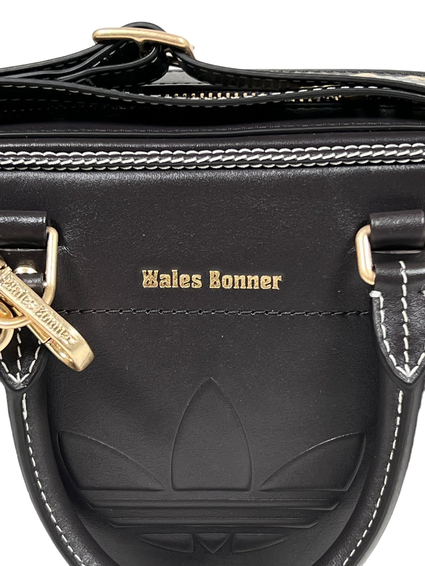 Black leather bag with an embossed ADIDAS x WALES BONNER logo, white stitching, and gold hardware. As part of the Wales Bonner collaboration, "Wales Bonner" is embossed in gold on the front.