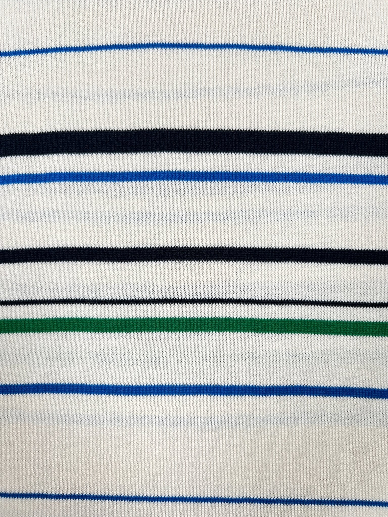 The Adidas x Wales Bonner JM8203 WB Knit Polo WonWh features a white base with blue, black, and green horizontal stripes of different thicknesses for a vintage-inspired look.
