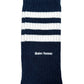 The Adidas x Wales Bonner JV8684 WB 3S Sock in navy features two white horizontal stripes near the top and “Wales Bonner” embroidered below the stripes.