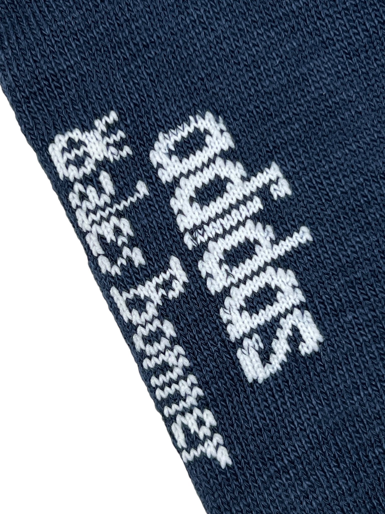 Close-up of navy blue knit fabric on ADIDAS x WALES BONNER JV8684 WB 3S Sock NtNavy, featuring the white Adidas logo and "skateboarding" text woven in white.