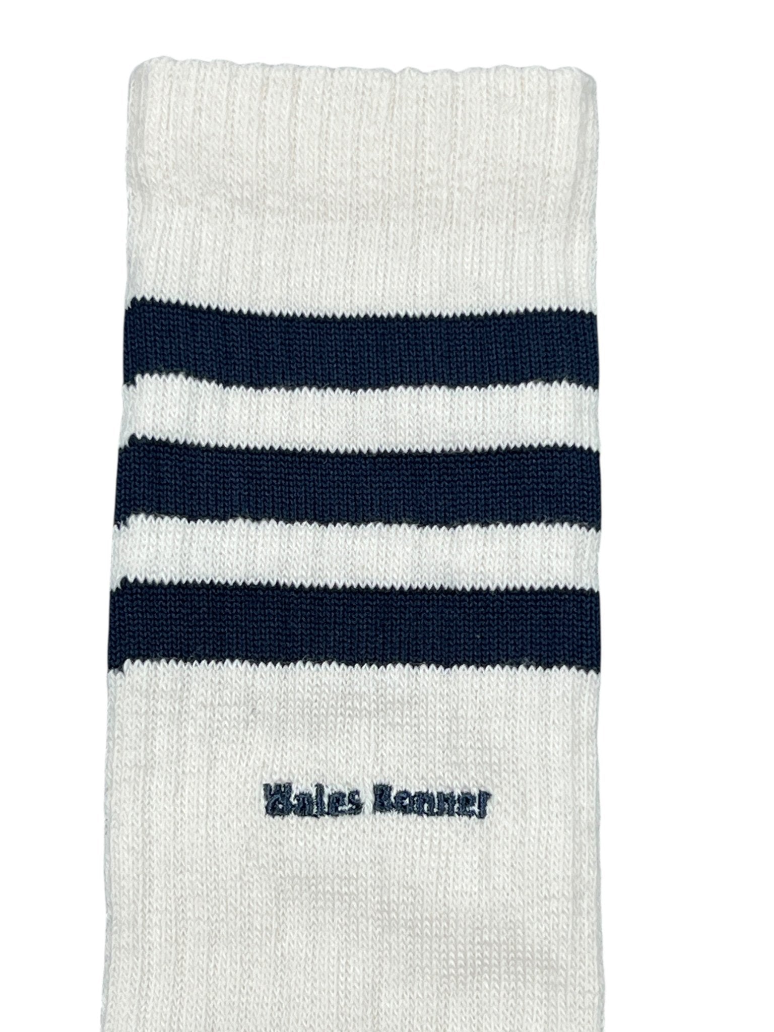 The ADIDAS x WALES BONNER JV8684 WB 3S Sock NtNavy is a white sock with three navy stripes and "Wales Bonner" embroidered by the ankle.