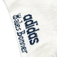 Close-up of the ADIDAS x WALES BONNER JV8684 WB 3S Sock NtNavy, a white knit sock showcasing the adidas logo and name in black with stylized text, referencing the signature collaboration aesthetic.