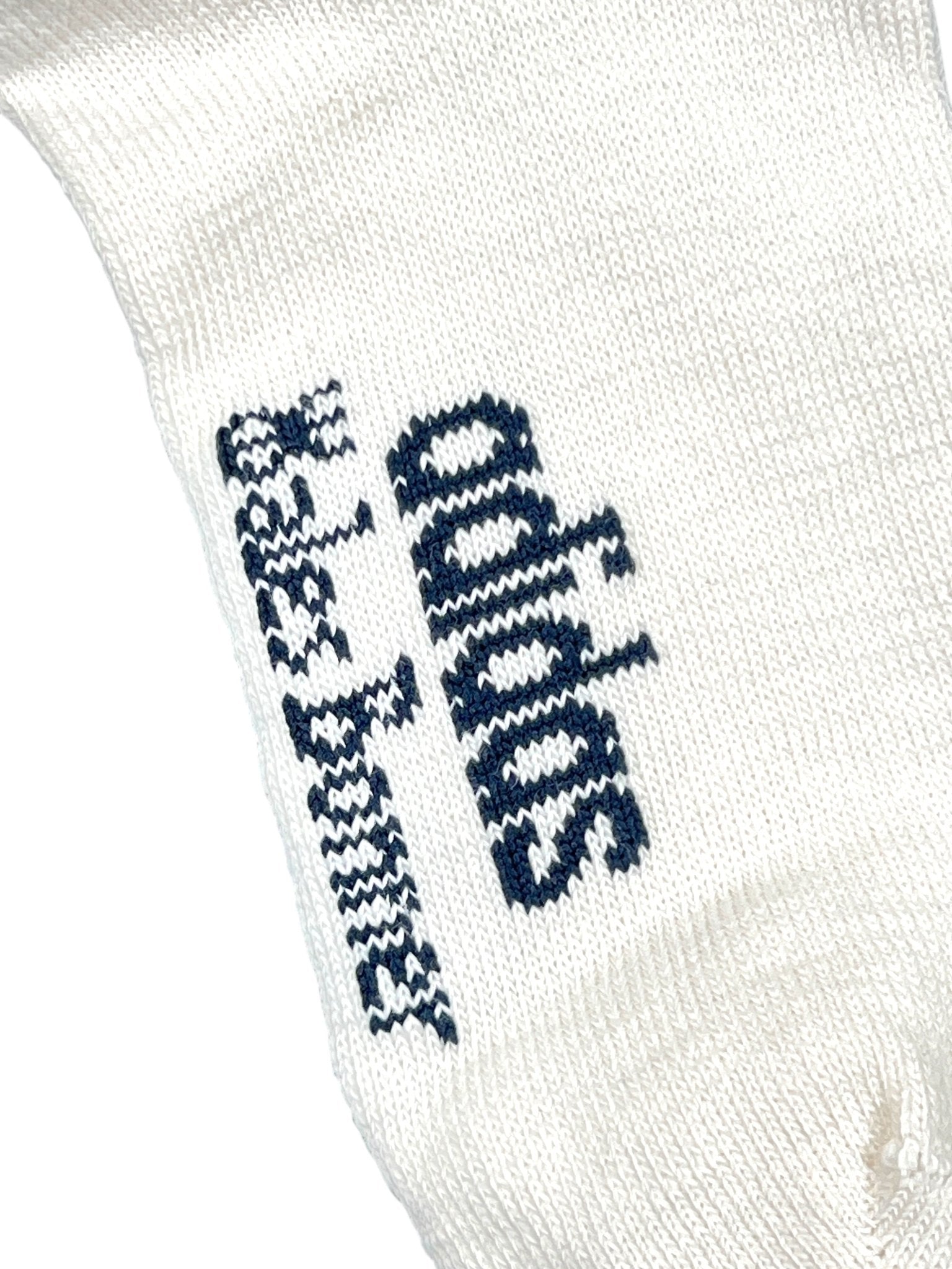 Close-up of the ADIDAS x WALES BONNER JV8684 WB 3S Sock NtNavy, a white knit sock showcasing the adidas logo and name in black with stylized text, referencing the signature collaboration aesthetic.