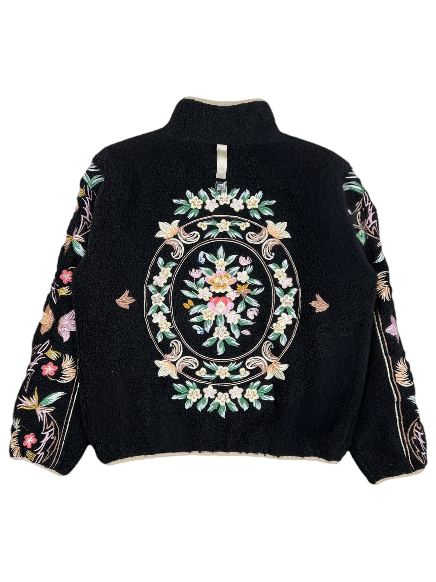 The Advisory Board Crystals Floral Fleece Zip-Up Black by ADVISORY BOARD CRYSTALS features a vibrant floral embroidery on the back and sleeves. Made from durable polyester, the central oval design showcases multicolored flowers and leaves, reflecting the brand's distinctive style.